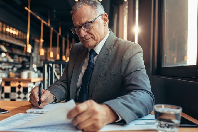 Mature man in suit working on new project budget