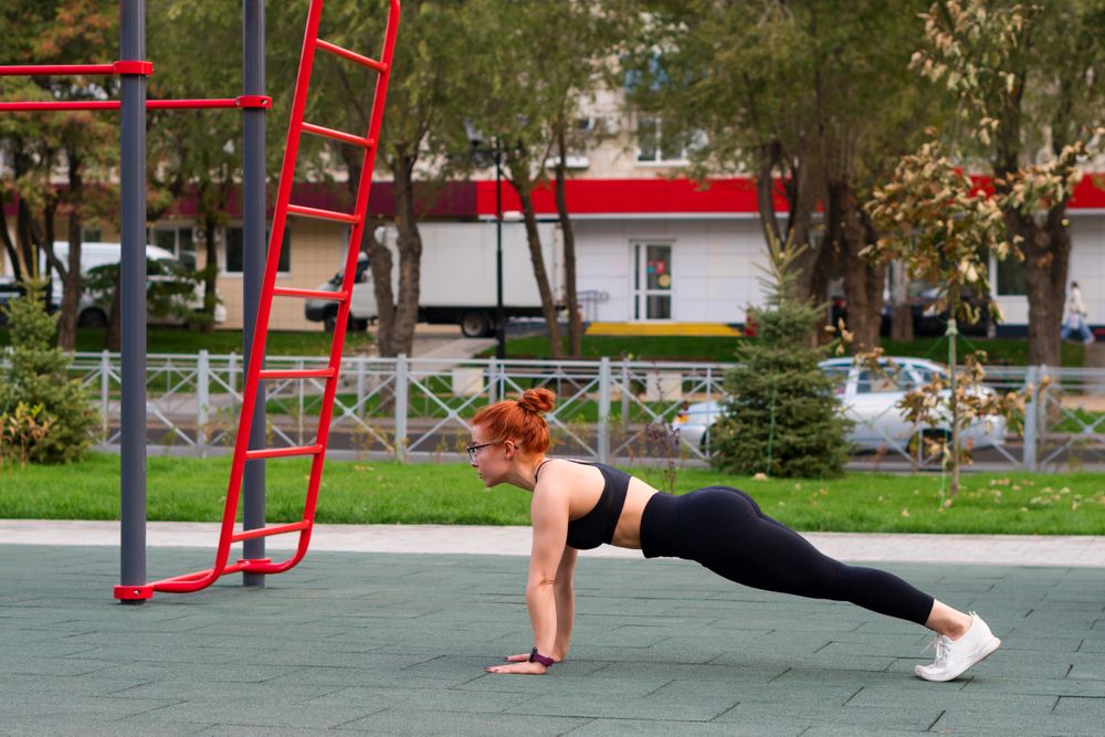 Woman doing plank exercise outdoor
