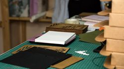 Paper with hole punch holes on table in warehouse in craft workshop