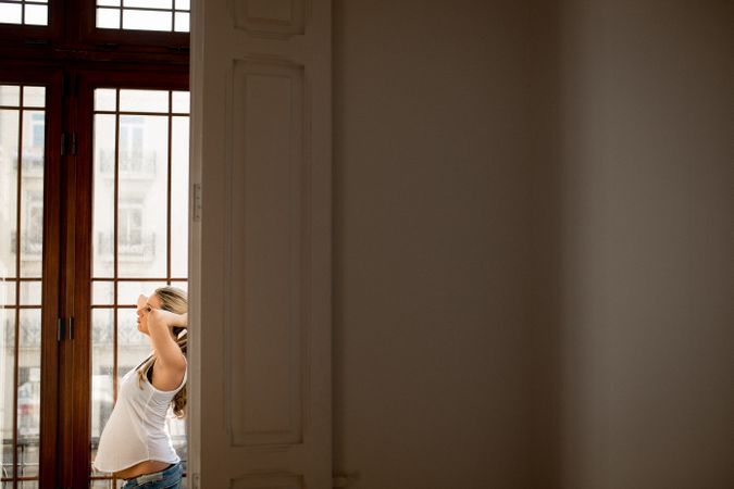 Pregnant woman near open door