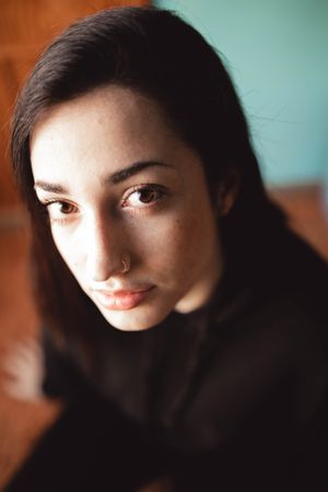 young woman looking straight ahead with serious attitude