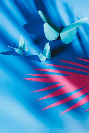 Paper butterflies on silk cloth