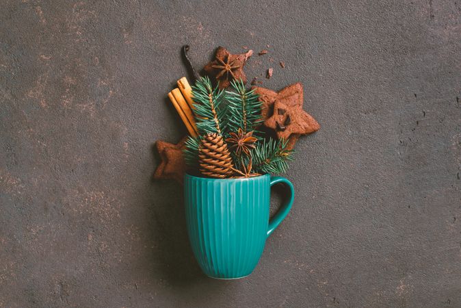 Blue mug with festive filling of pine, gingerbread cookies and anise