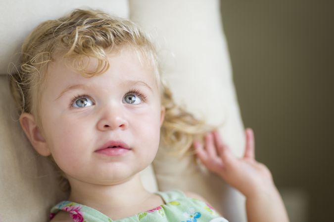 Adorable Blonde and Blue Eyed Little Girl in Chair