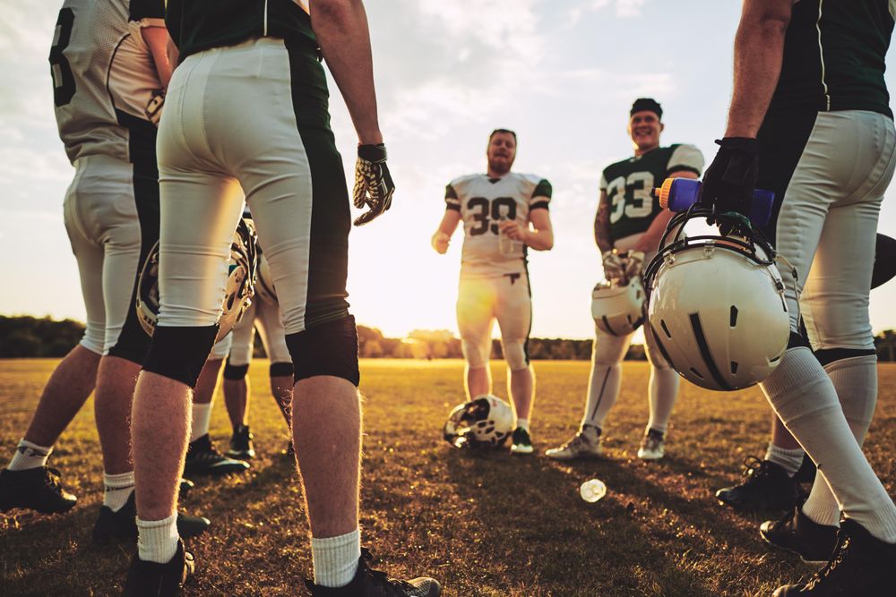 A football team strategizing together during practise