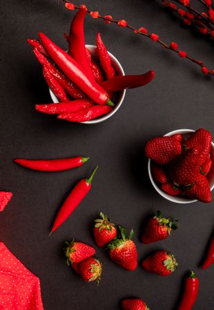 Cloth and branches near peppers and strawberries