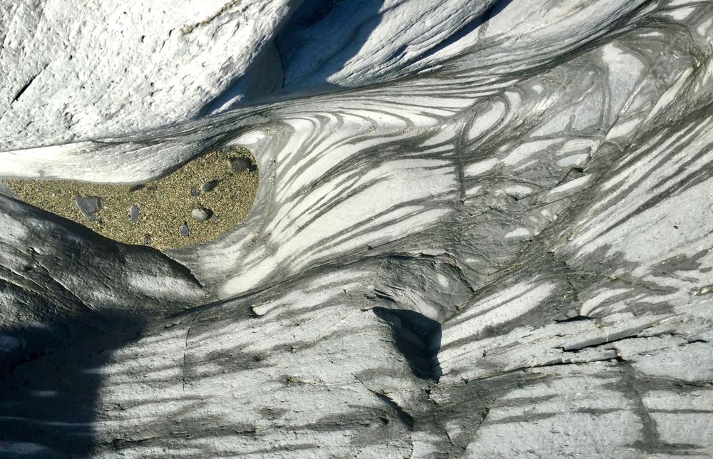 smooth rocks with wavy patterns eroded by the sea