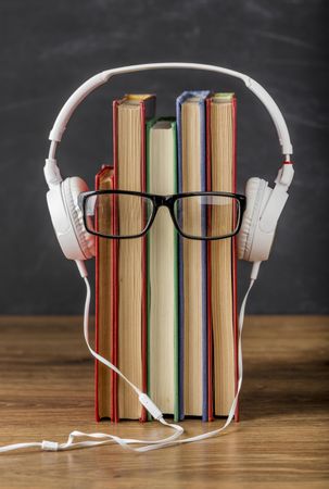 Arrangement of books with headphones