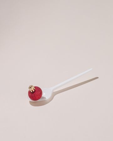 Red Christmas bauble on a spoon