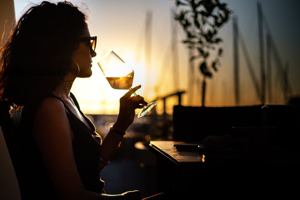 Woman holding clear wine glass