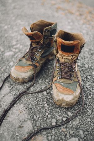 Shabby boots on gravel road