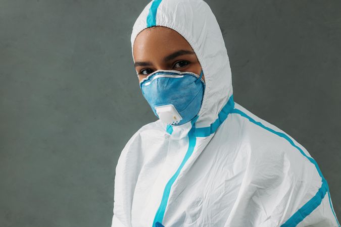 Black woman in hazmat suit and face mask