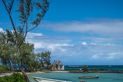 Scene of fishing boats anchored in the sand in Mauritius