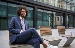 Glad entrepreneur smiling while sitting outside