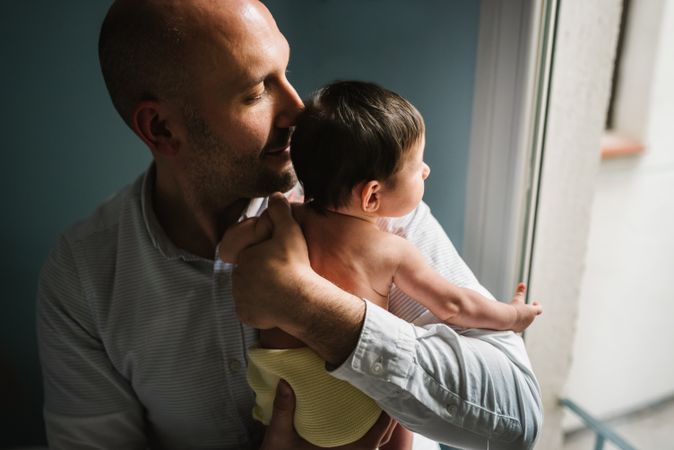 Father hugging cute baby