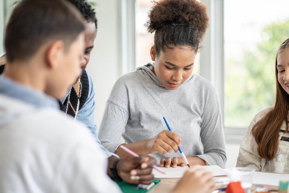Teenage students in painting class