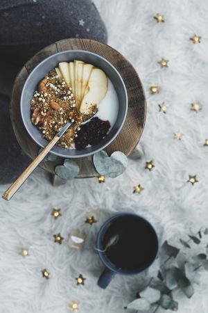 Smoothie bowl on wooden board with cup of tea