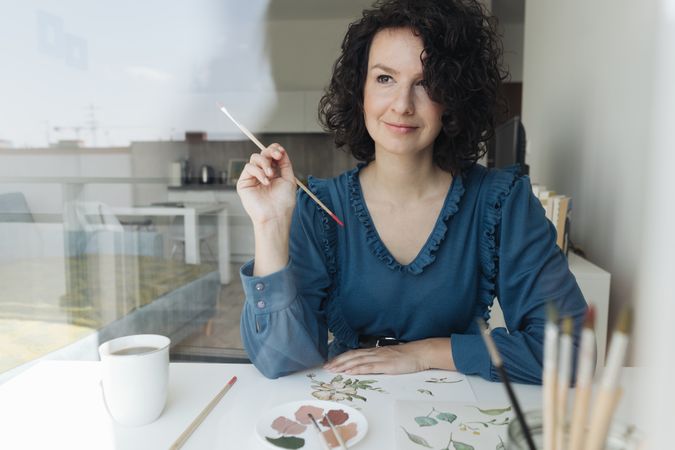Woman painter working at home
