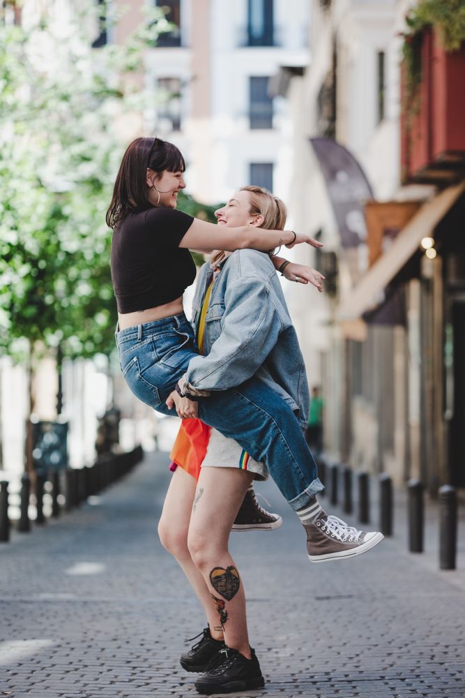 Happy lesbian couple having fun on street