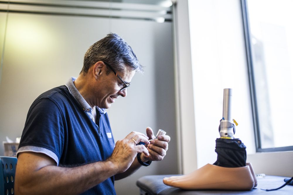 man fixing a prosthesis in a workshop