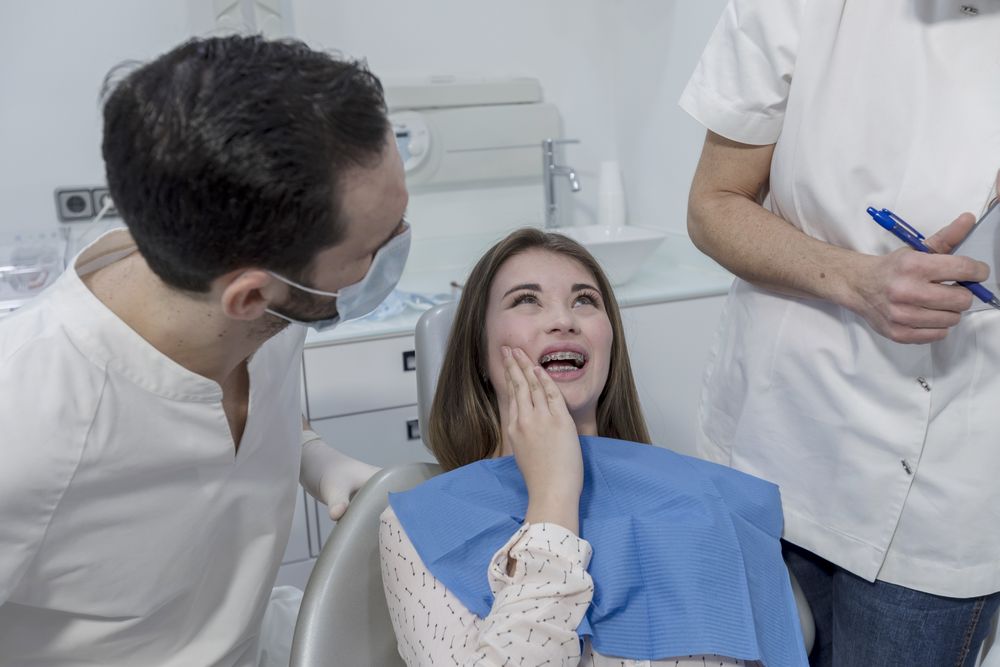 Portrait of a dentist and a young patient in the dentist clinic