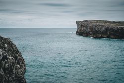 Sea and cliffs on cloudy day