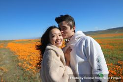 Man and woman hugging and standing on yellow flower field 5wGRW5