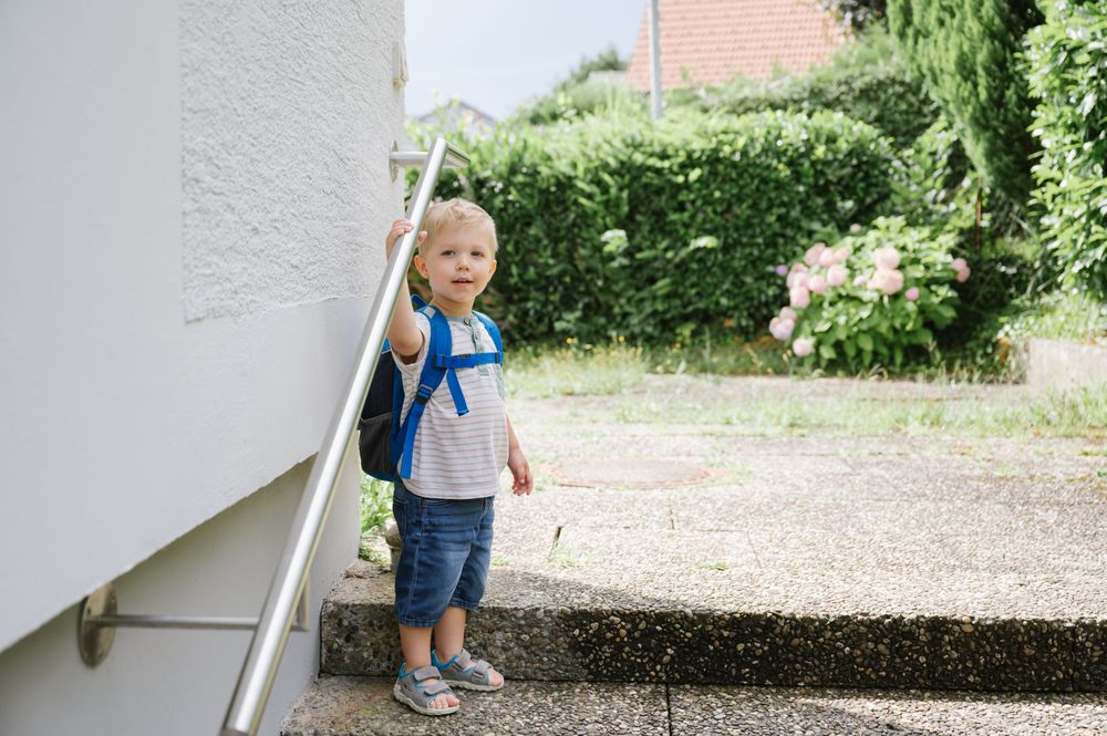 Happy child with backpack standing outside
