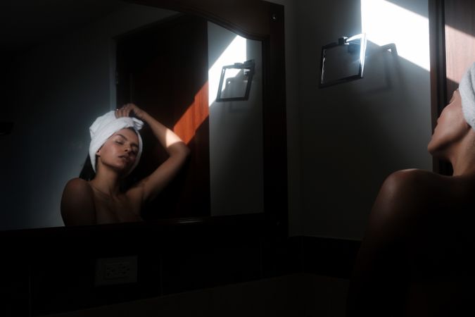 woman against mirror in bathroom