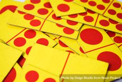 Red & yellow domino cards scattered on table 5oDq2y
