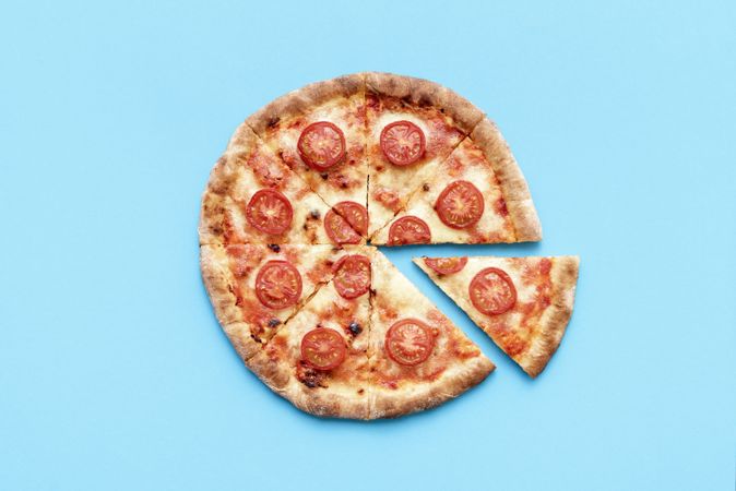 Homemade pizza top view on a blue background