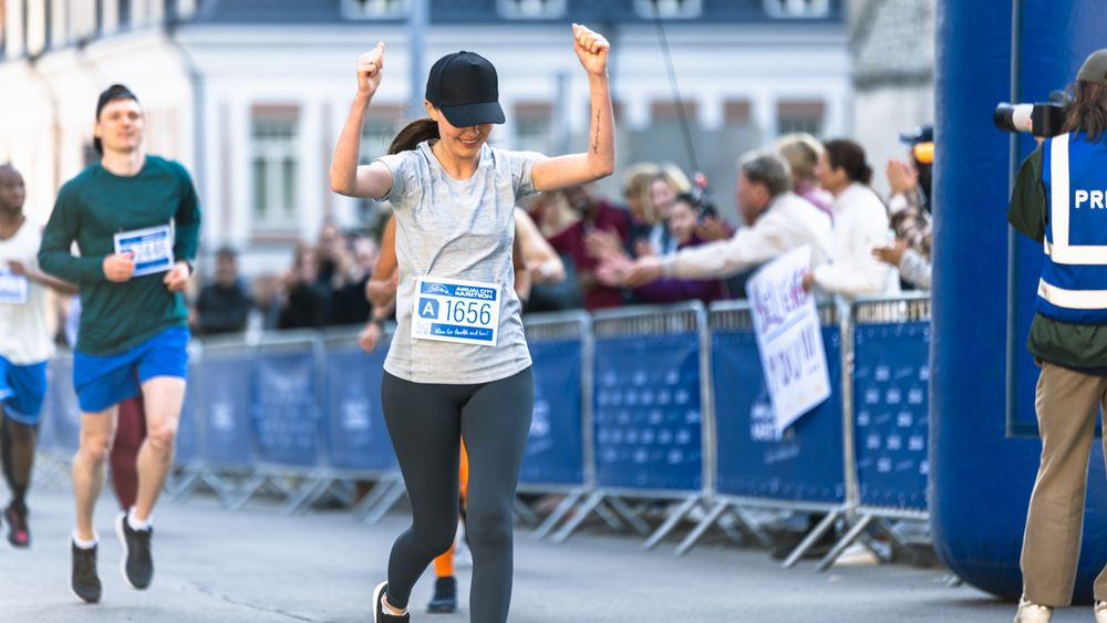 Portrait of Happy Female Runner Participating in a Marathon.
