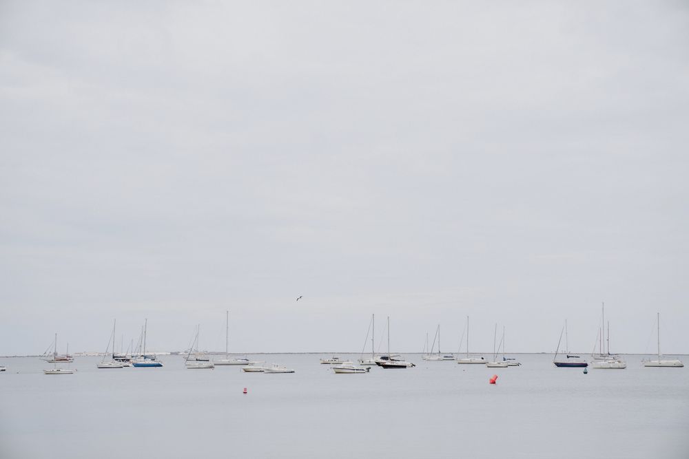 Yachts against overcast sky