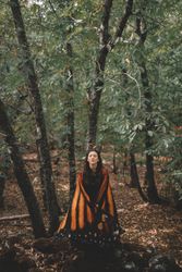 Woman in butterfly costume in forest