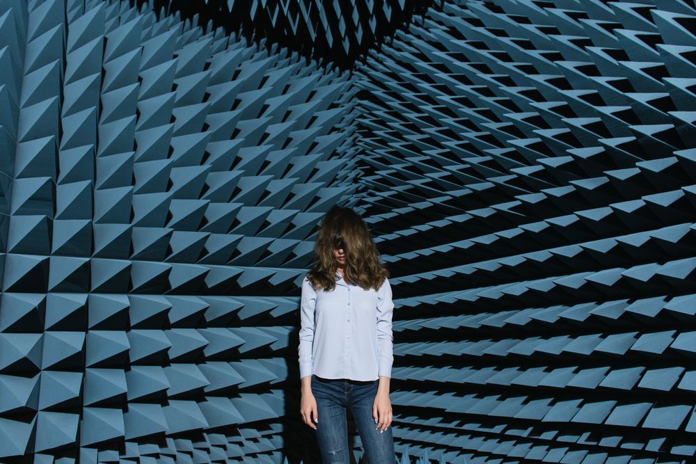 Woman in middle of sound room shaking head