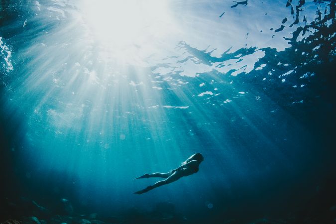 Underwater shot of woman diving during daytime