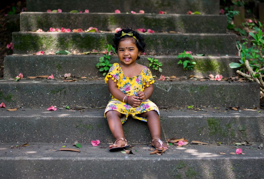 Portrait of girl sitting on concrete steps