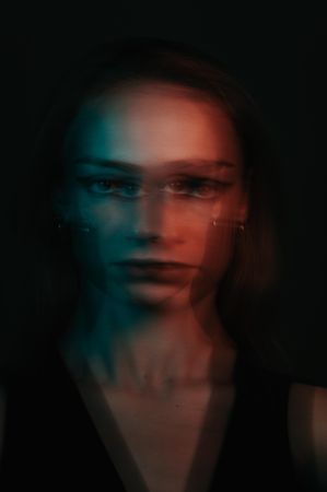Blurry portrait of young woman in UV light