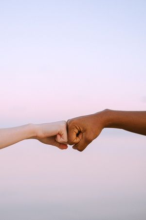 Cropped image of two hands fist bump