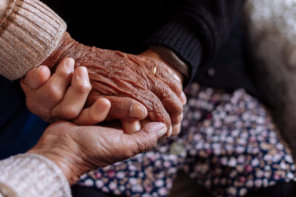 Detail of the hands of an older couple