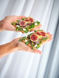 Crop person with arranged fruit slices in both hands