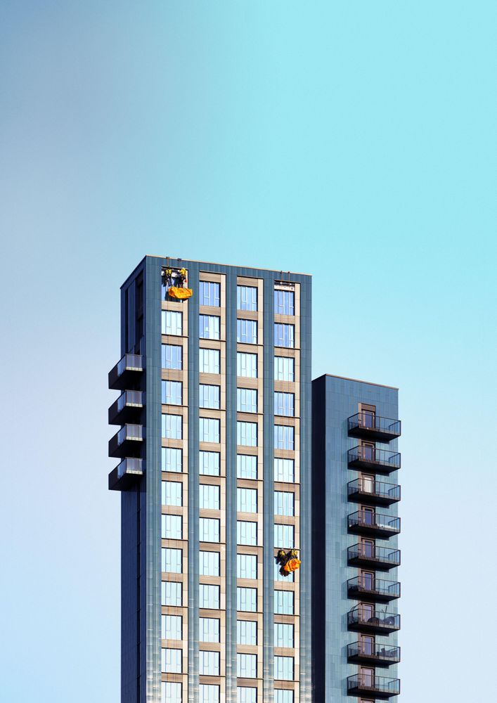 Window cleaners working on a tall residential building
