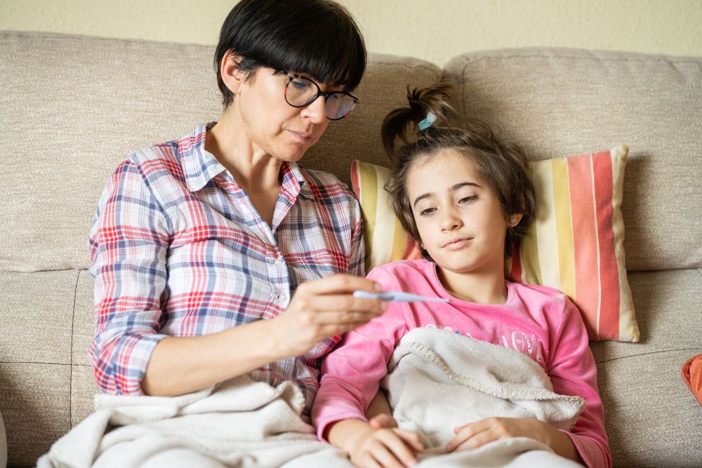 Mother sitting with her sick daughter