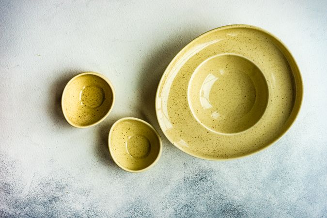 Rustic table setting with three yellow bowls