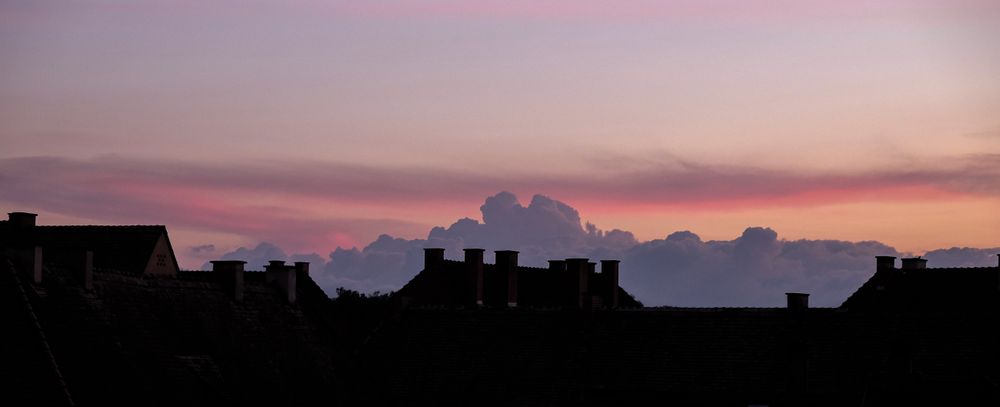 Beautiful purple clouds over a French village, wide