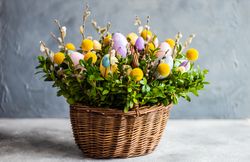 Easter card concept with fresh basket of greenery with colorful decorative eggs