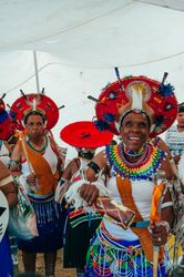 Zulu woman elder laughs looking at camera before dancing