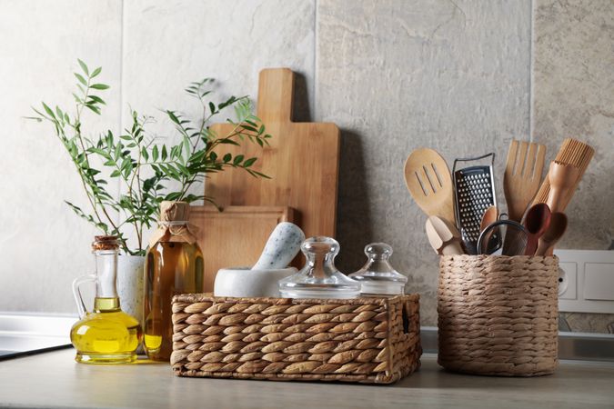 Kitchen table with different supplies and vase with plant