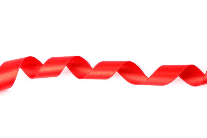 Red ribbon isolated on plain background. Gift concept