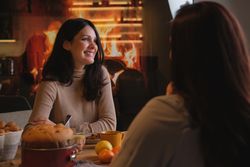 Women having fun and eating cake at home
